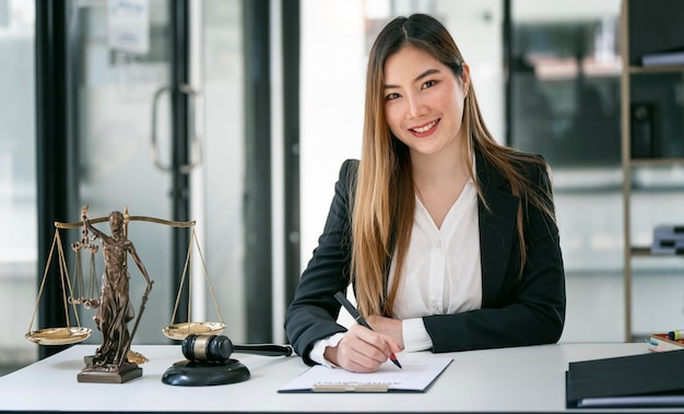 Portrait of young female Lawyer or attorney working in the office smiling and looking at camera