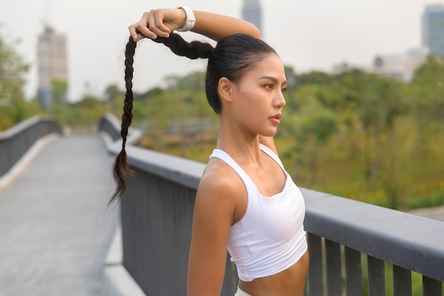 Portrait of young fitness woman in sportswear in city park Healthy and Lifestyles