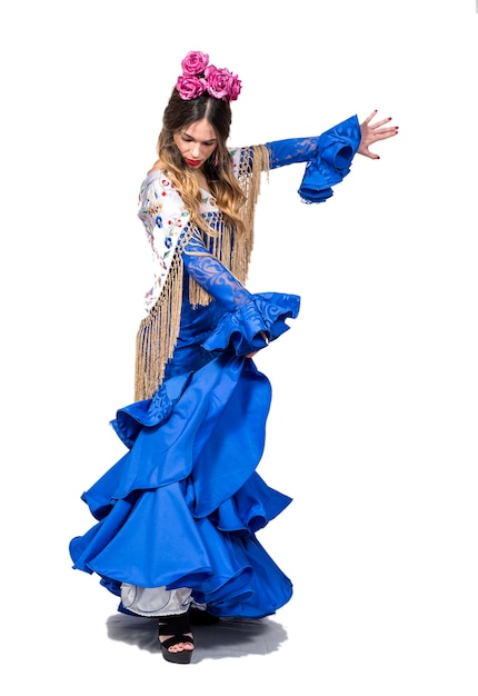 Portrait of young flamenco dancer in beautiful dress with white isolated background