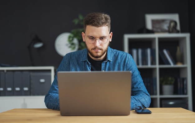 Portrait of young focused man coding