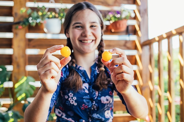 Portrait of a young girl holding delicious fruits