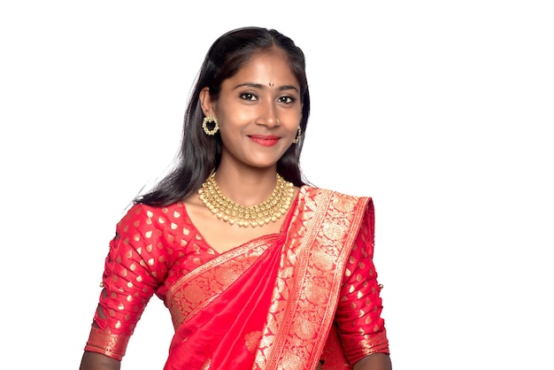 Portrait of a young girl on Indian traditional saree posing on a white background