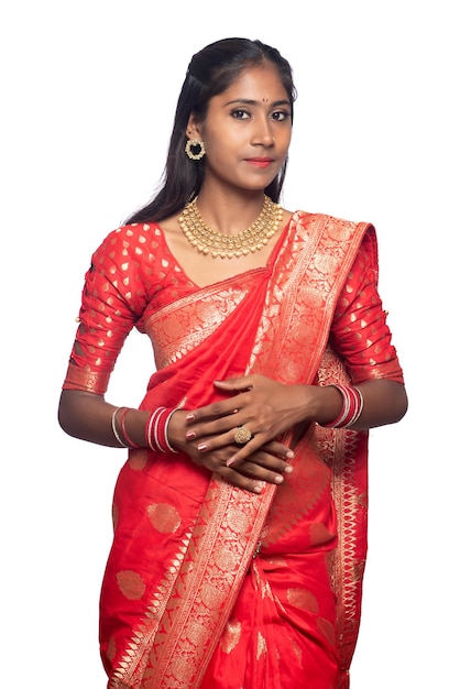 Portrait of a young girl on Indian traditional saree posing on a white background