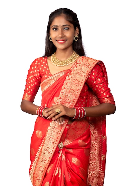 Portrait of a young girl on Indian traditional saree posing on a white background