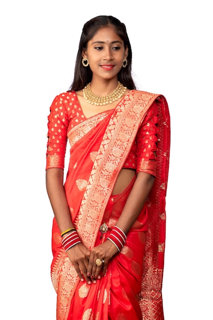 Portrait of a young girl on Indian traditional saree posing on a white background