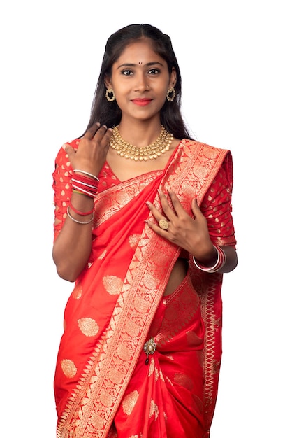 Portrait of a young girl on Indian traditional saree posing on a white background