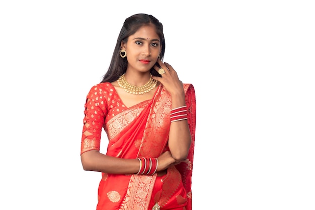 Portrait of a young girl on Indian traditional saree posing on a white background