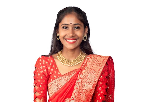 Portrait of a young girl on Indian traditional saree posing on a white background