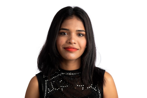 Portrait of a young girl wearing black dress posing on a white background