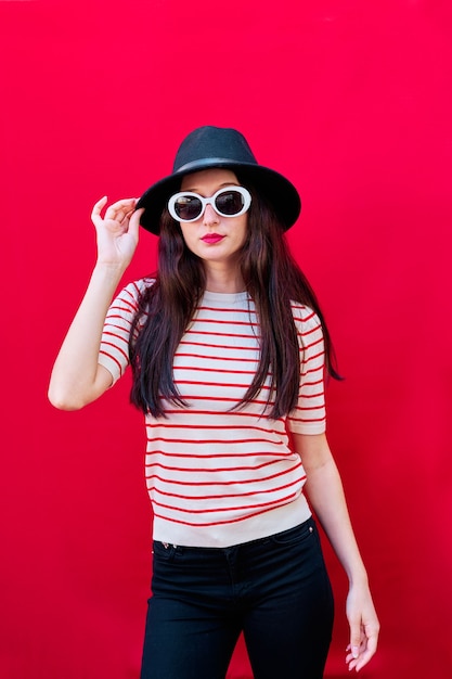 Portrait of a young girl with sunglasses and hat