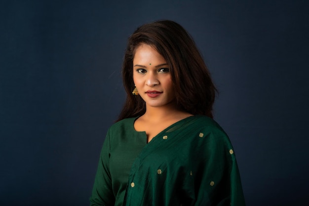 Portrait of a young girl or woman posing on gray background