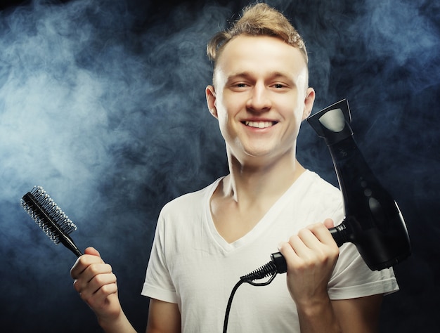 Portrait of young hairstylist looking at camera