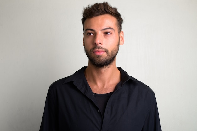 portrait of young handsome bearded businessman on white