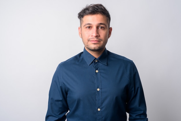 Portrait of young handsome Iranian businessman on white