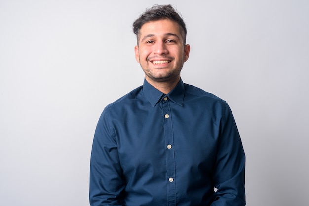 Portrait of young handsome Iranian businessman on white