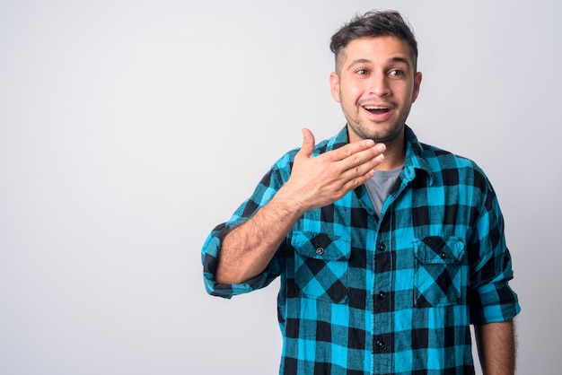 Portrait of young handsome Iranian hipster man on white