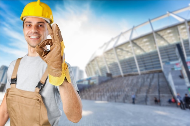 Portrait of young handsome man in yellow helmet