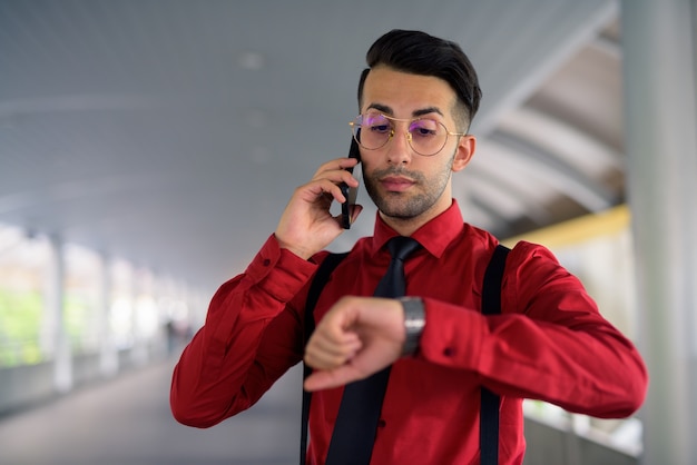 Portrait of young handsome Persian businessman exploring the city of Bangkok, Thailand