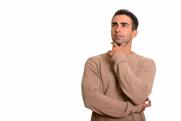 Portrait of young handsome Persian man planning and thinking