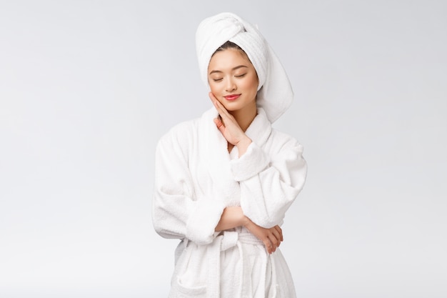 Portrait of a young happy asian lady in bathrobe.