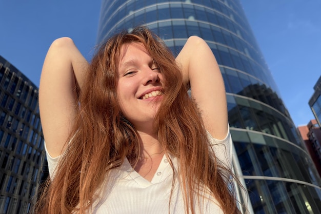 Portrait of young happy beautiful woman with red hair businesswoman in business centre or college