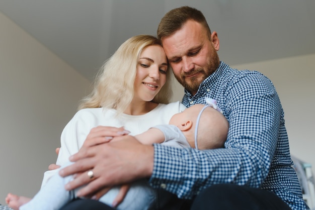 Portrait of a young happy family with the kid