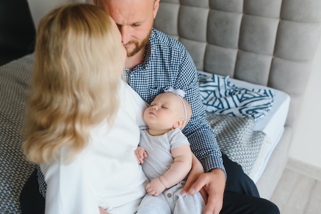 Portrait of a young happy family with the kid