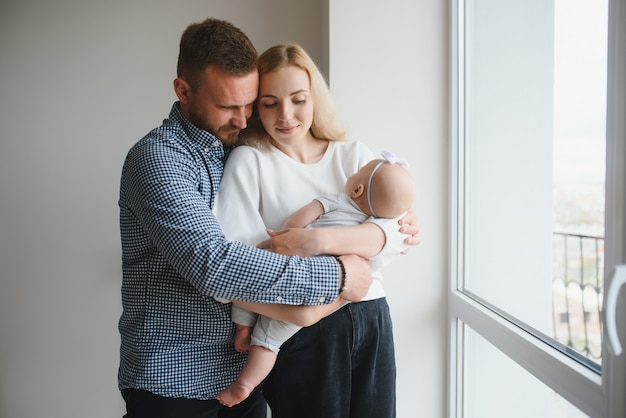 Portrait of a young happy family with the kid