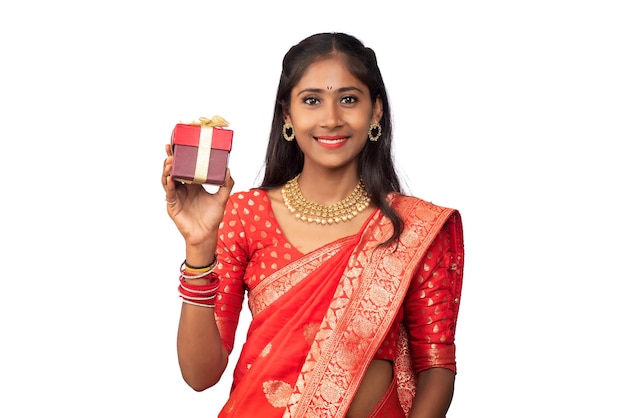 Portrait of young happy smiling Girl holding gift box on a white background