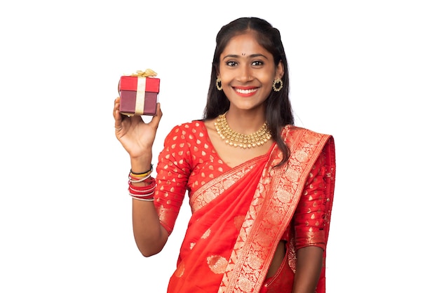 Portrait of young happy smiling Girl holding gift box on a white background