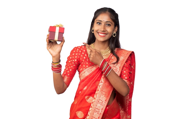 Portrait of young happy smiling Girl holding gift box on a white background