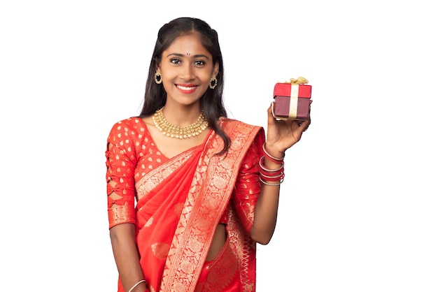 Portrait of young happy smiling Girl holding gift box on a white background