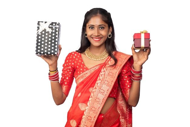 Portrait of young happy smiling Girl holding gift box on a white background