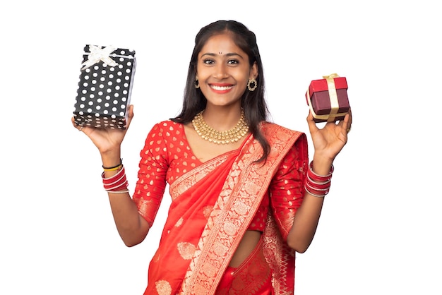 Portrait of young happy smiling Girl holding gift box on a white background