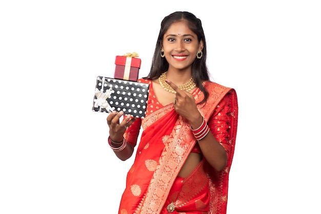 Portrait of young happy smiling Girl holding gift box on a white background