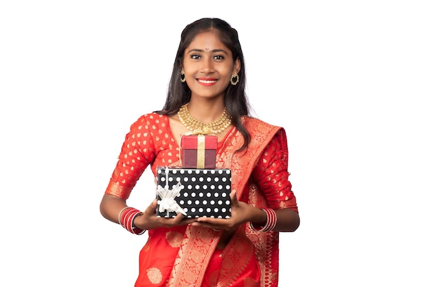 Portrait of young happy smiling Girl holding gift box on a white background