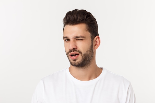 Portrait of the young happy smiling handsome man isolated on a white