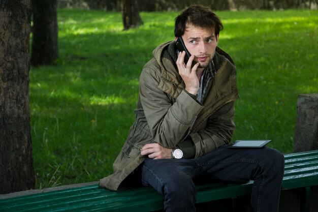 Portrait of young hipster man talking on mobile phone.