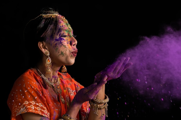 Portrait Of Young Indian Women With Color Face celebrating Holi Color festival. Festival in india.