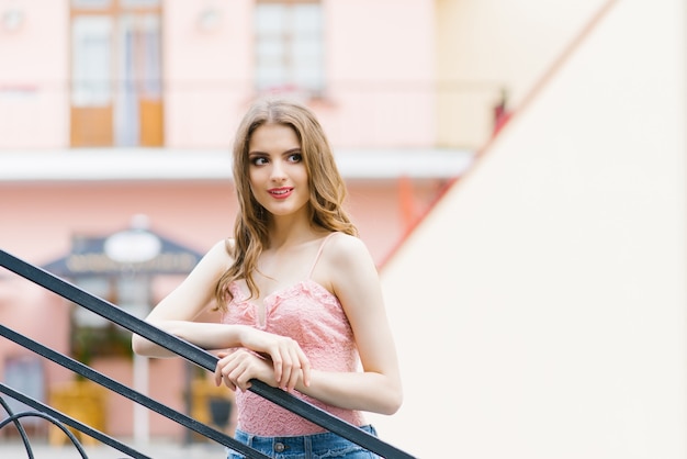 Portrait of a young lady expressing feminine pleasure while looking into the distance. Copy the space on the right side