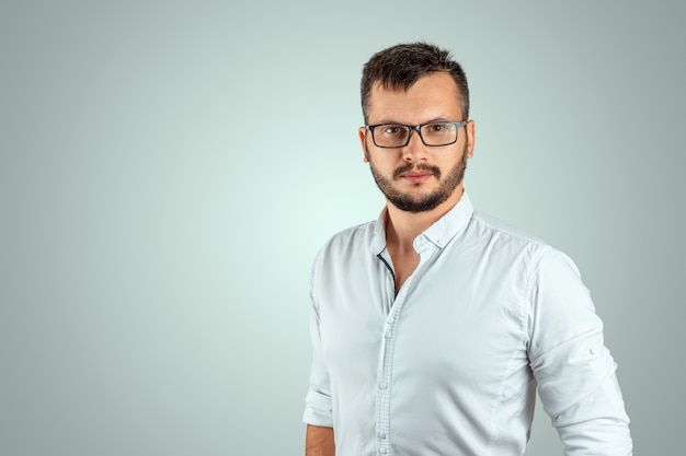 Portrait of a young male teacher on a light background