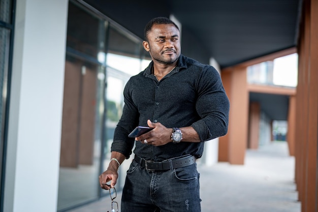 Portrait of young man in black shirt Fahionable elegant male model in darl casual cloth