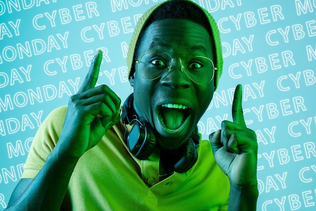 Portrait of young man on blue background, black friday