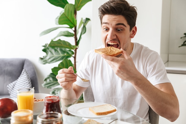 Portrait of a young man having breakfast