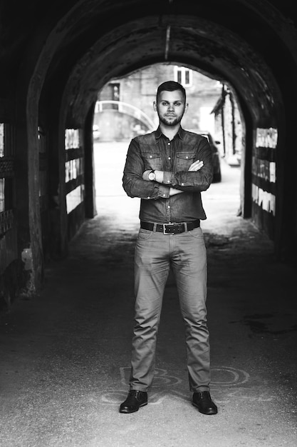 Photo portrait of a young man in a shirt and trousers