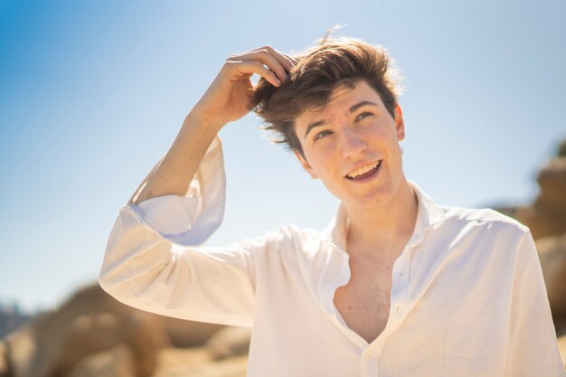 Portrait of a young man smiling whit white shirt