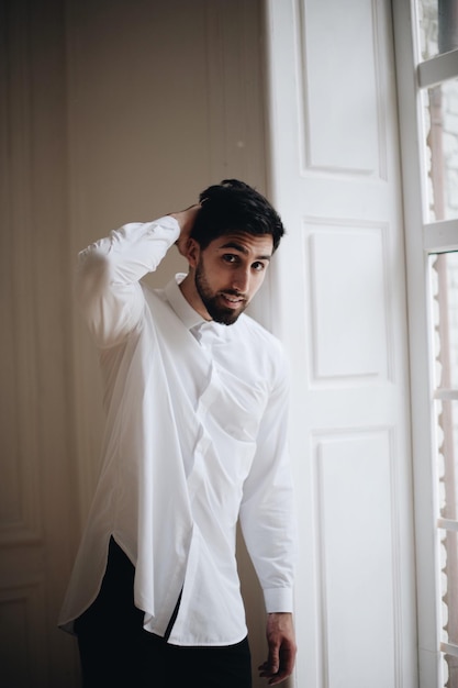 Portrait of young man standing at home