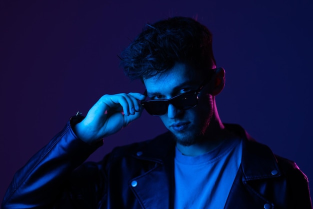 Portrait young man in sunglass isolated gradient violet color background