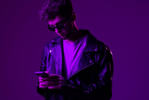 Portrait young man in sunglass isolated gradient violet color background