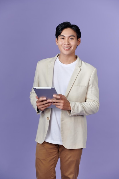 Portrait of a young man using tablet computer